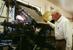 Albert M. Elias stands next to a 1914 linotype, the typesetting machine that helped to print the El Tucsonense newspaper in the early years. photo: Steve Renzi