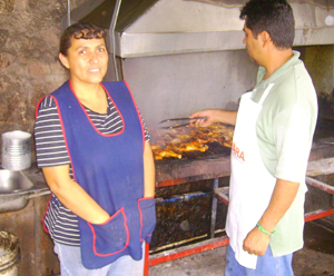 Fernanda & Roberto Rodriguez cooking at their outdoor grill to sell dished to the community; Nogales, Sonora, Mexico. photo: Bill Holliday
